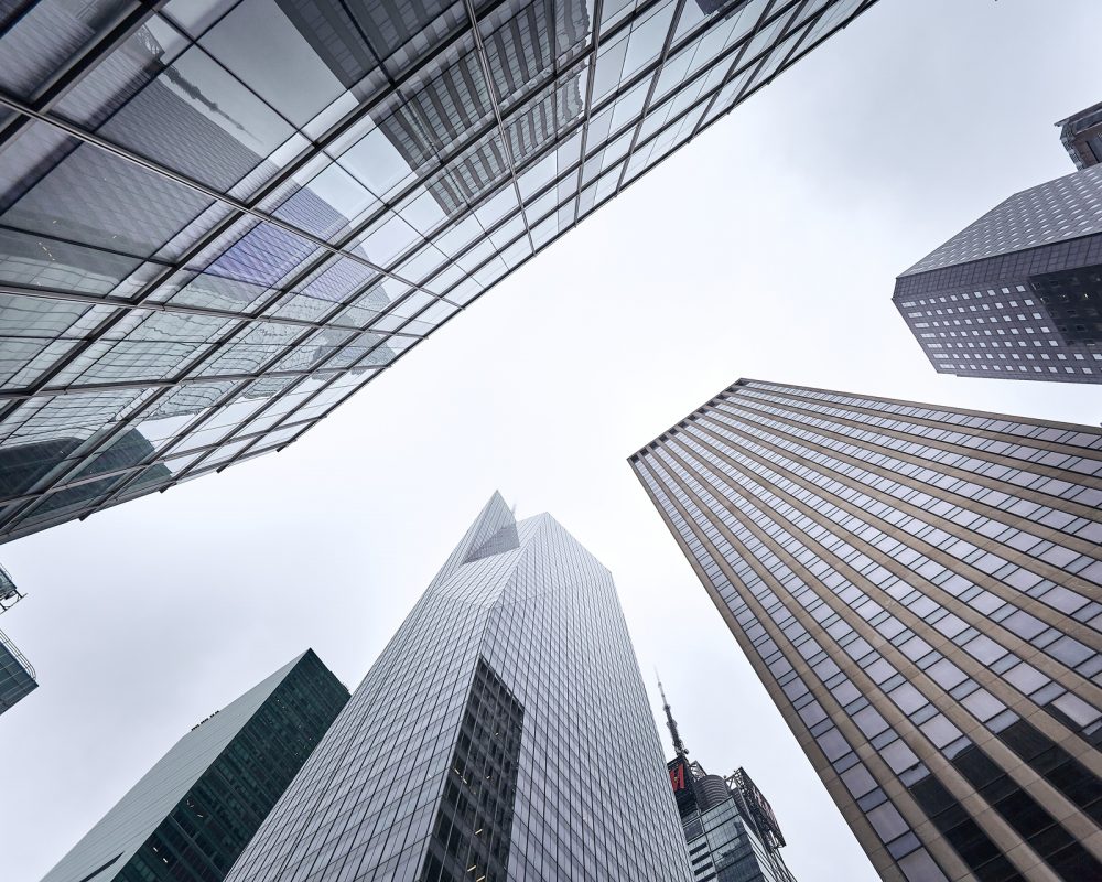 A low angle shot of the skyscrapers against the blue sky in Manhattan, New York City